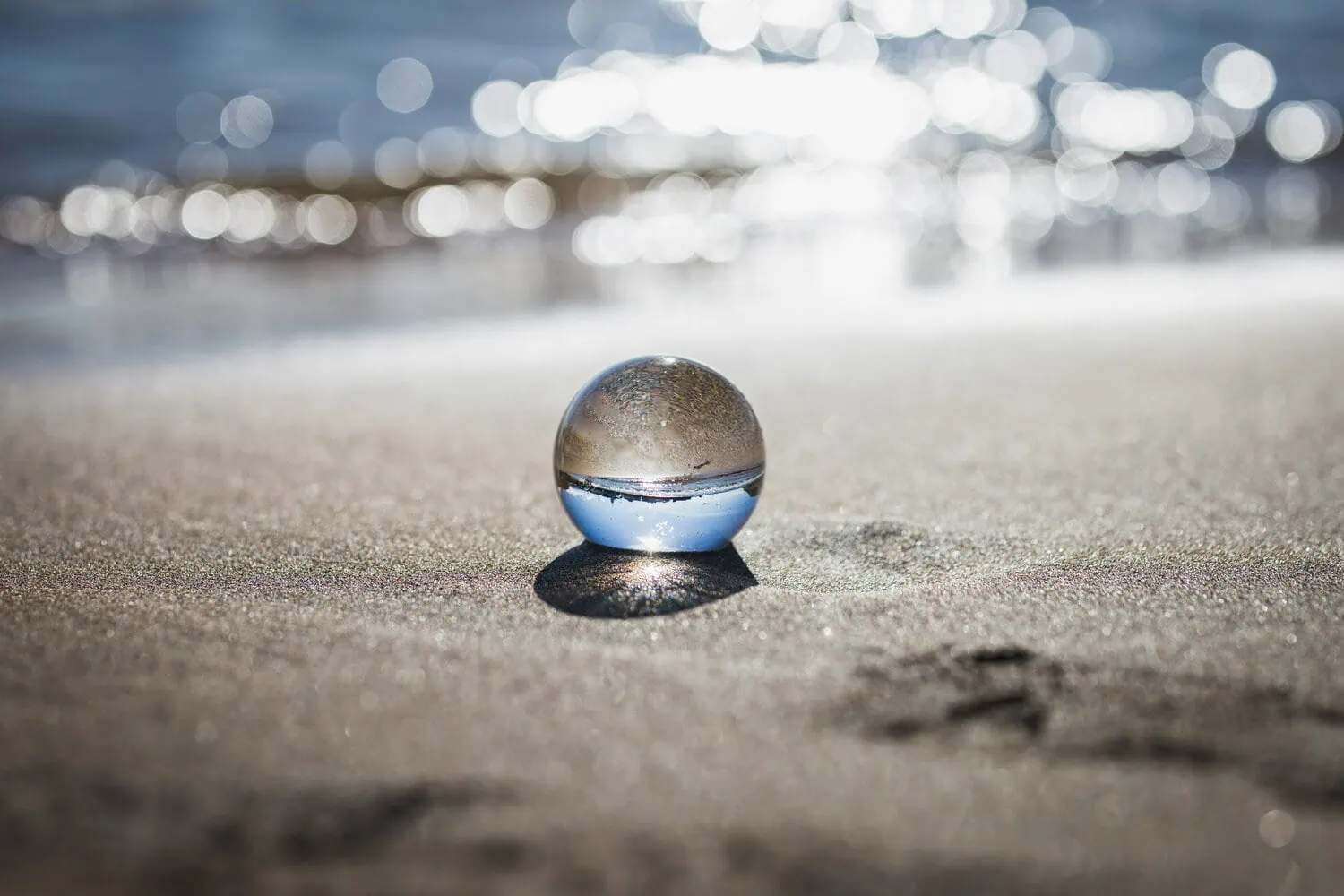 A clear glass ball on a beach representing clarity and how to stand out from competitors in a crowded B2B market